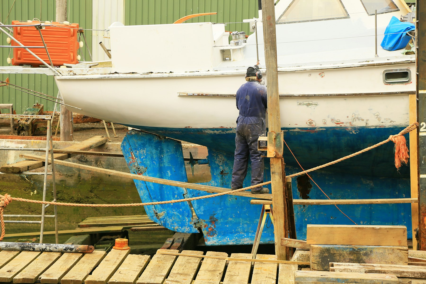 Marine mechanic repairing a boat engine at the dock